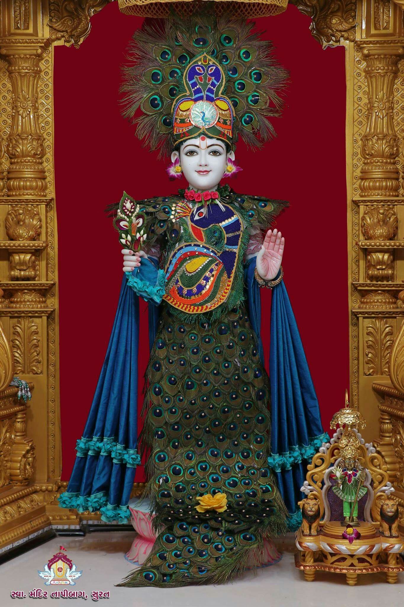 Swaminarayan adorned with peacock feathers.