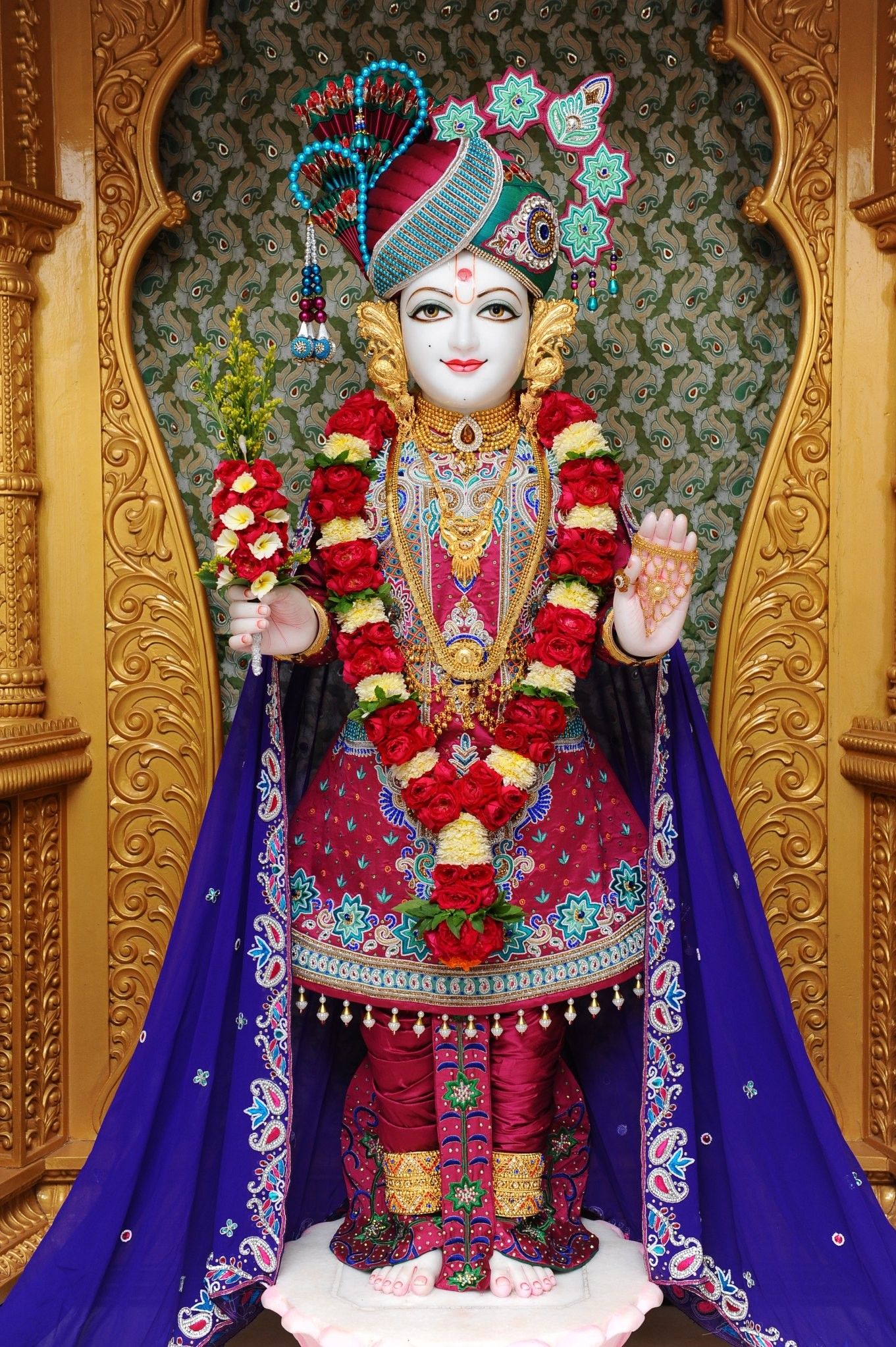 Swaminarayan with floral garland and blessings