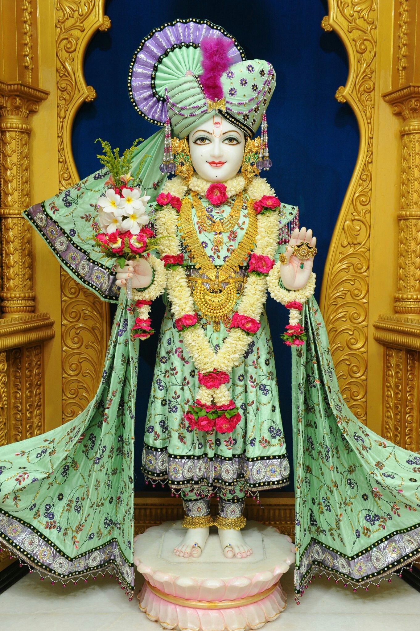 Swaminarayan idol with floral decorations