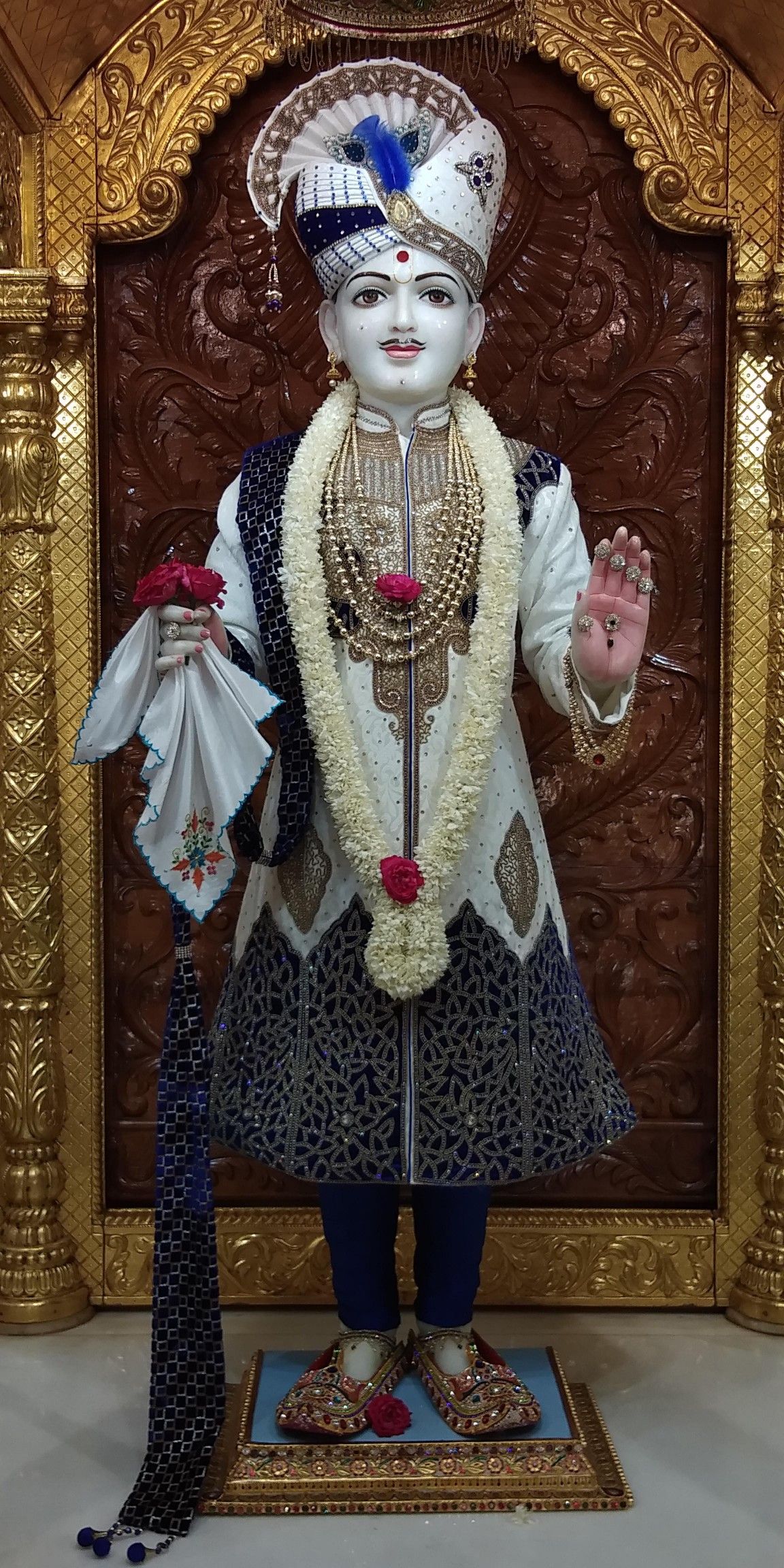 Swaminarayan murti with floral garland