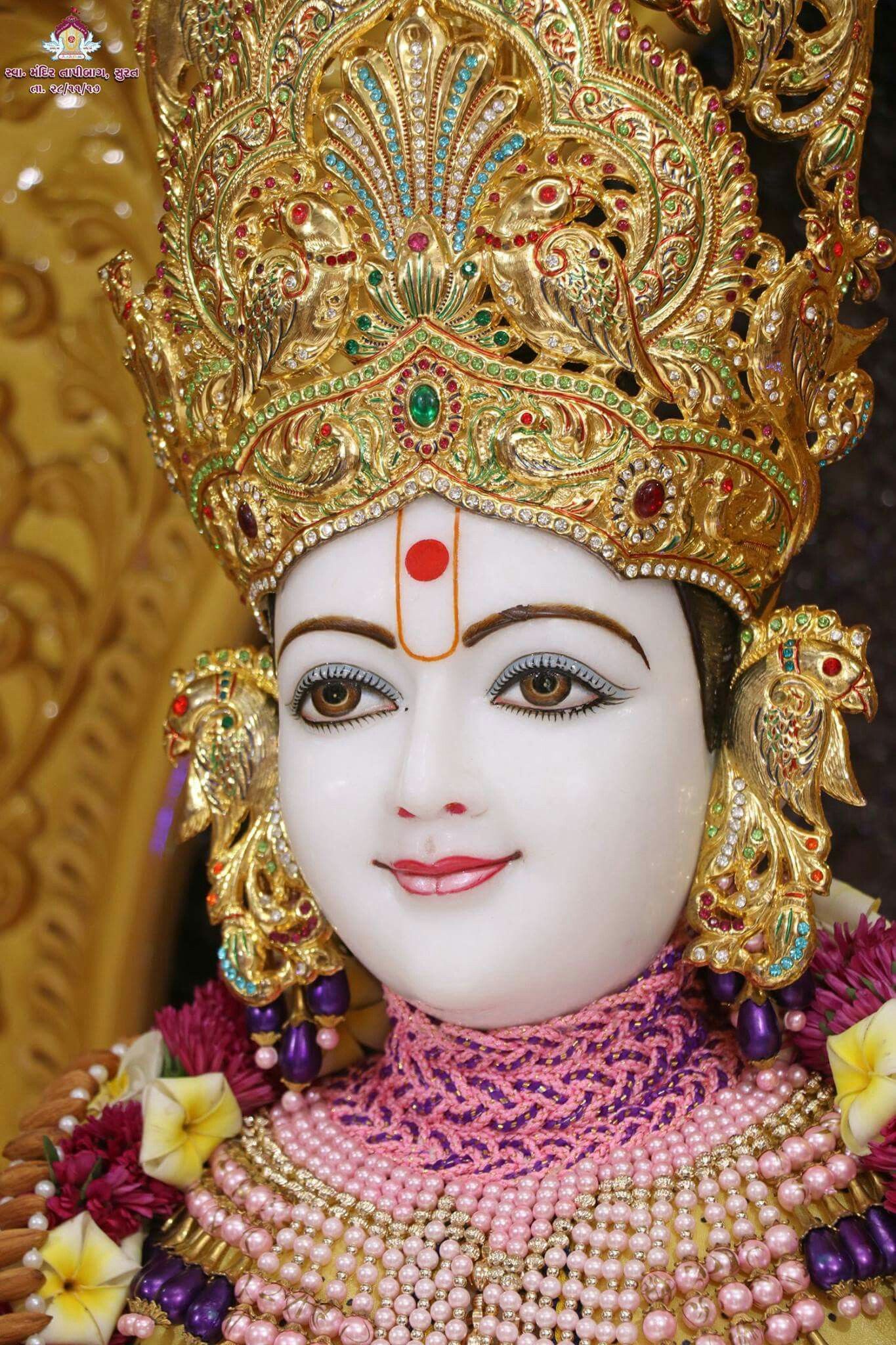 Detailed Swaminarayan murti with gold jewelry