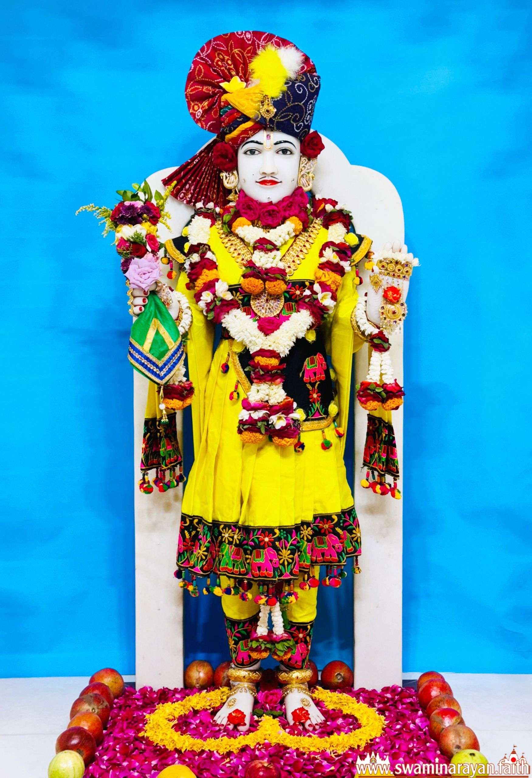 Swaminarayan deity adorned with garlands.
