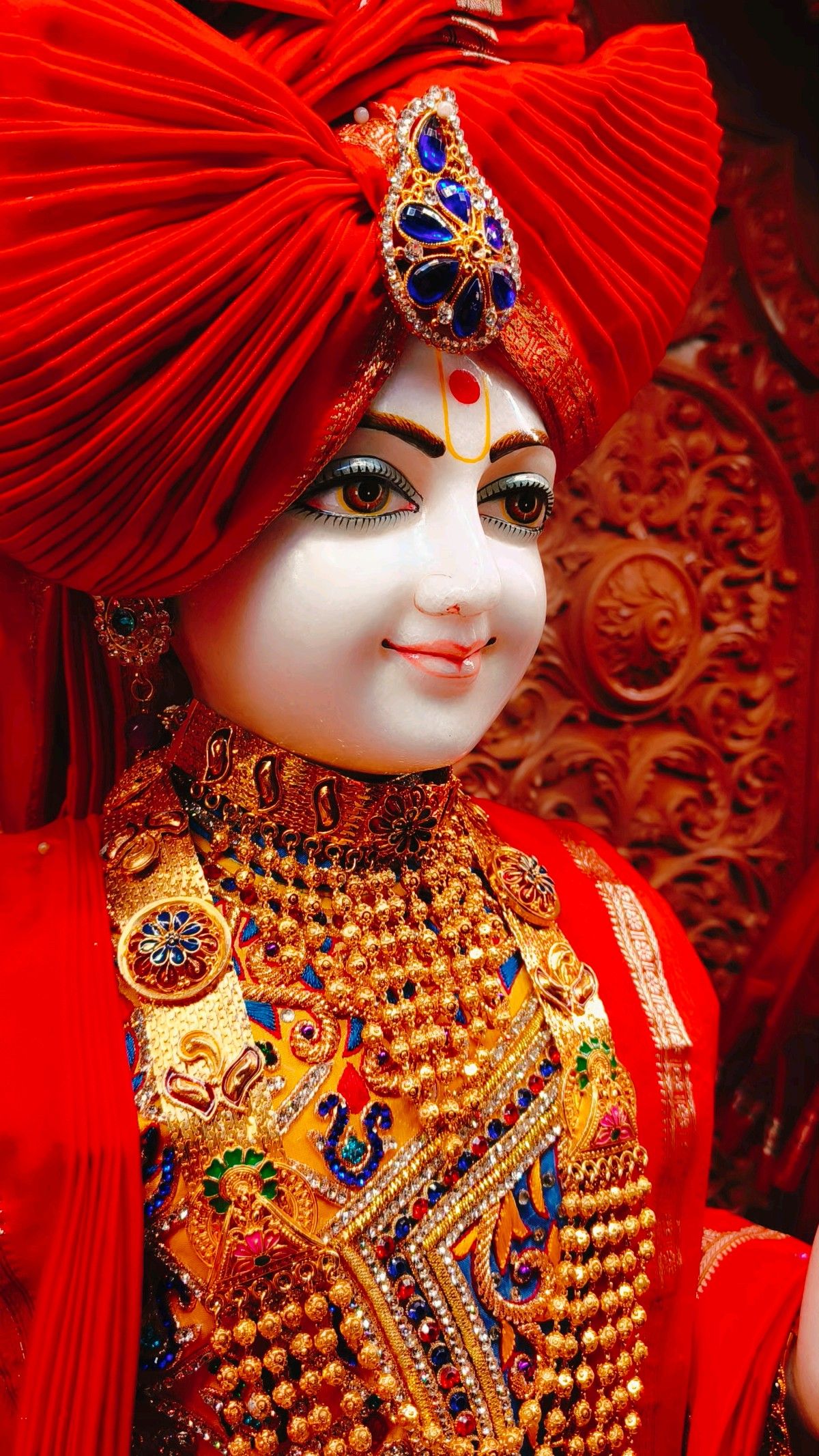 Close-up of Swaminarayan with golden adornments