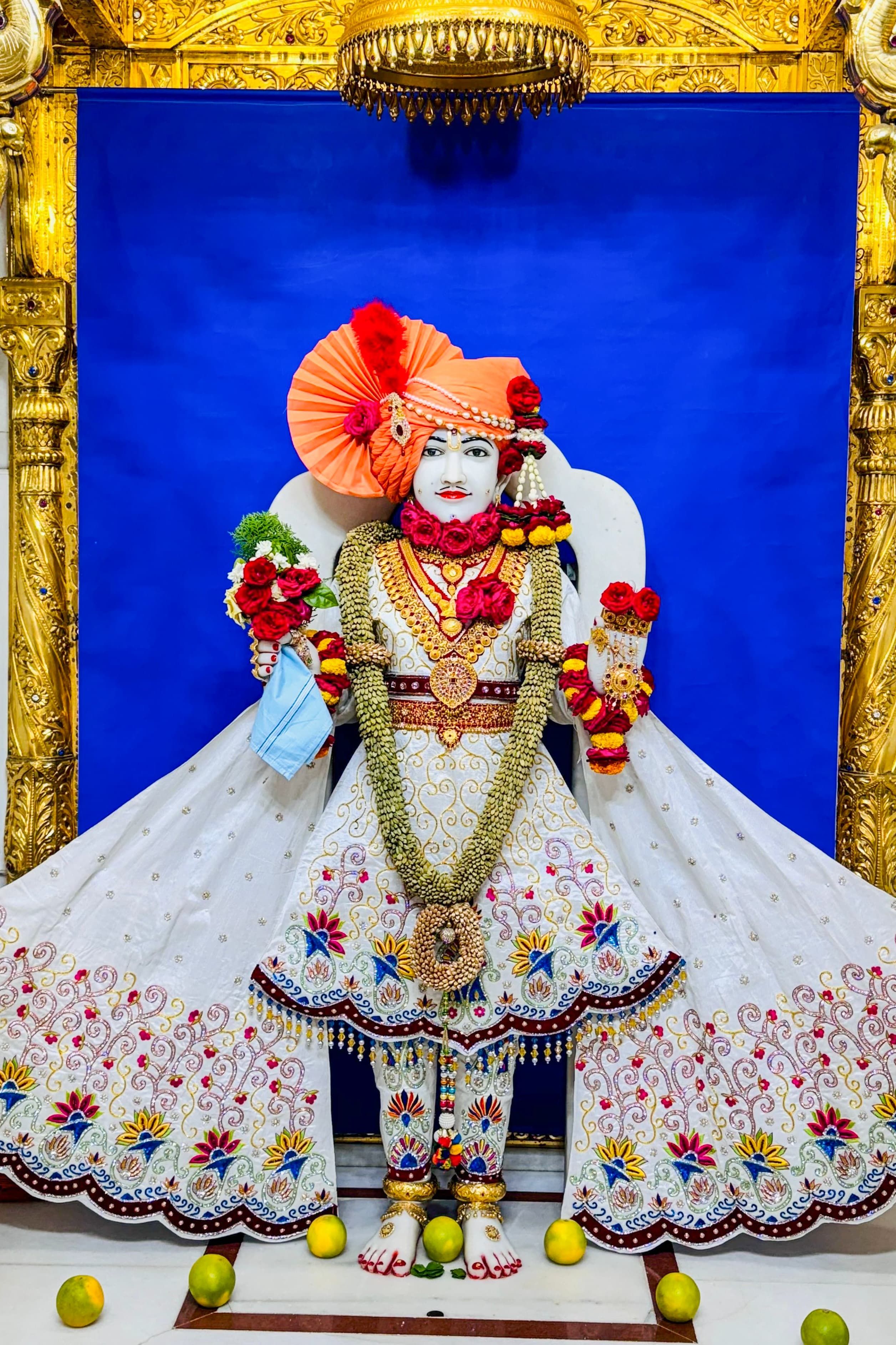 Swaminarayan statue with floral decorations