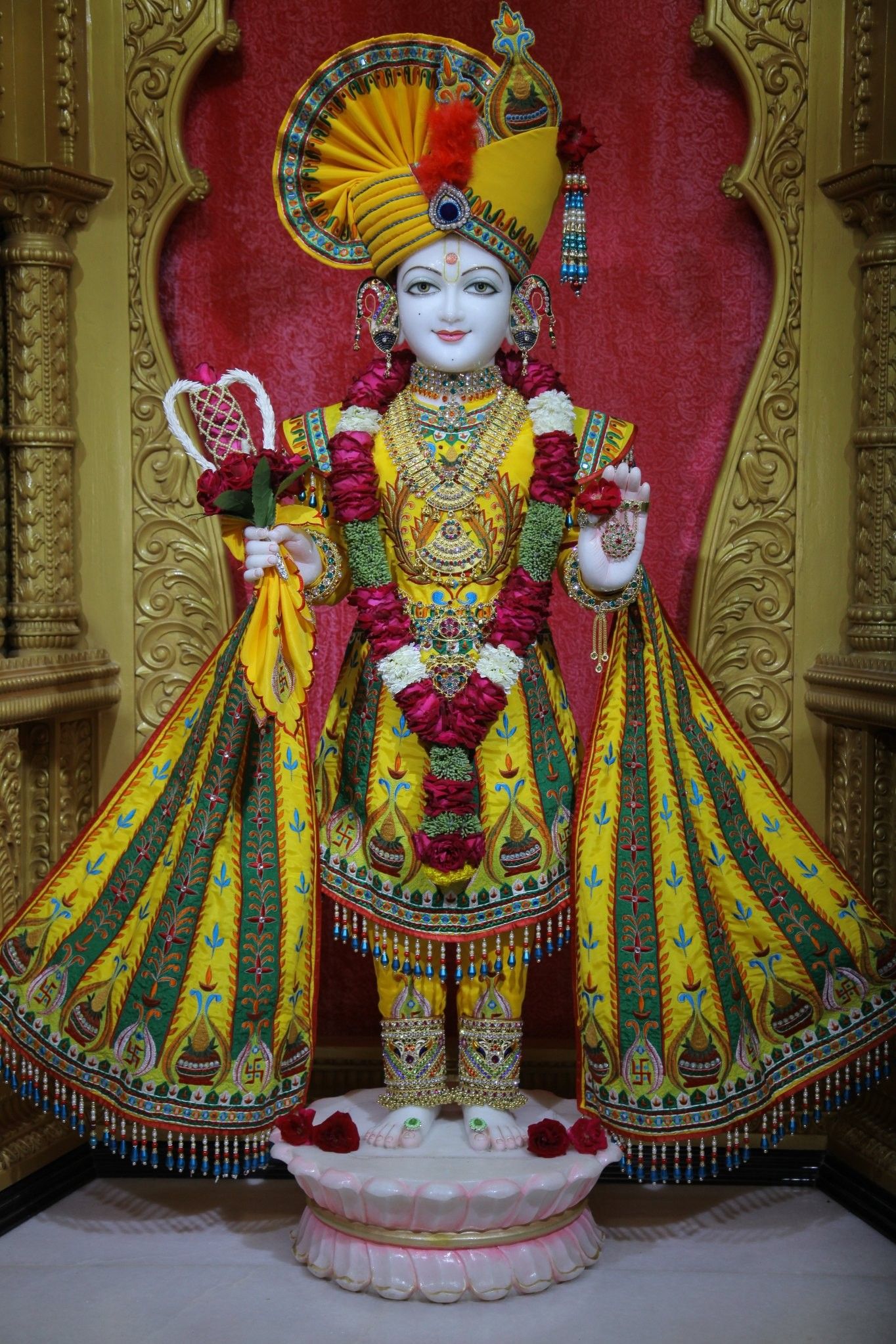 Swaminarayan statue adorned with flowers