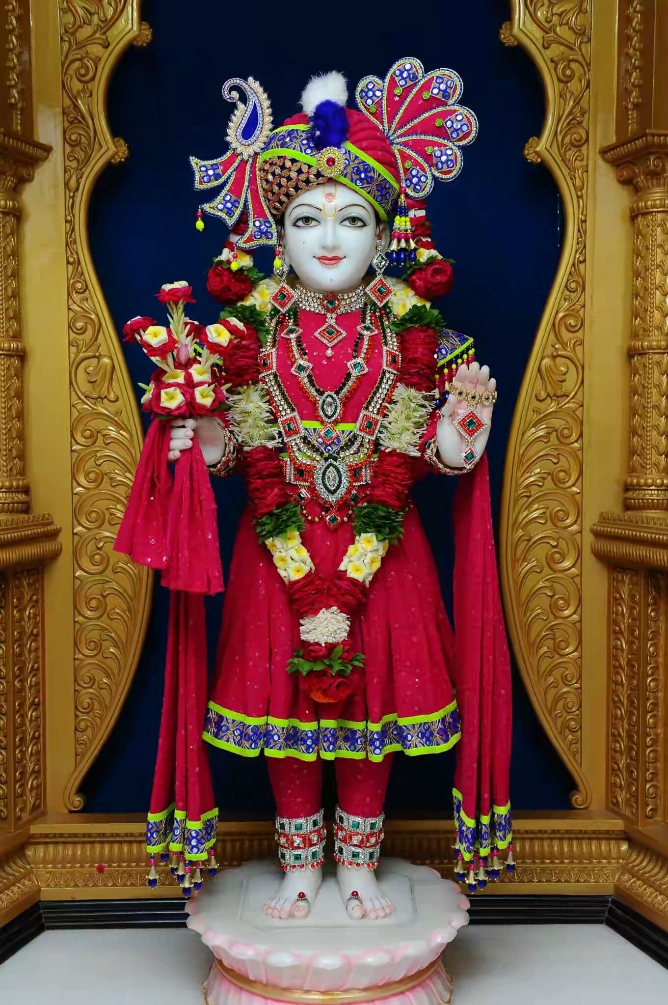 Swaminarayan deity in red attire