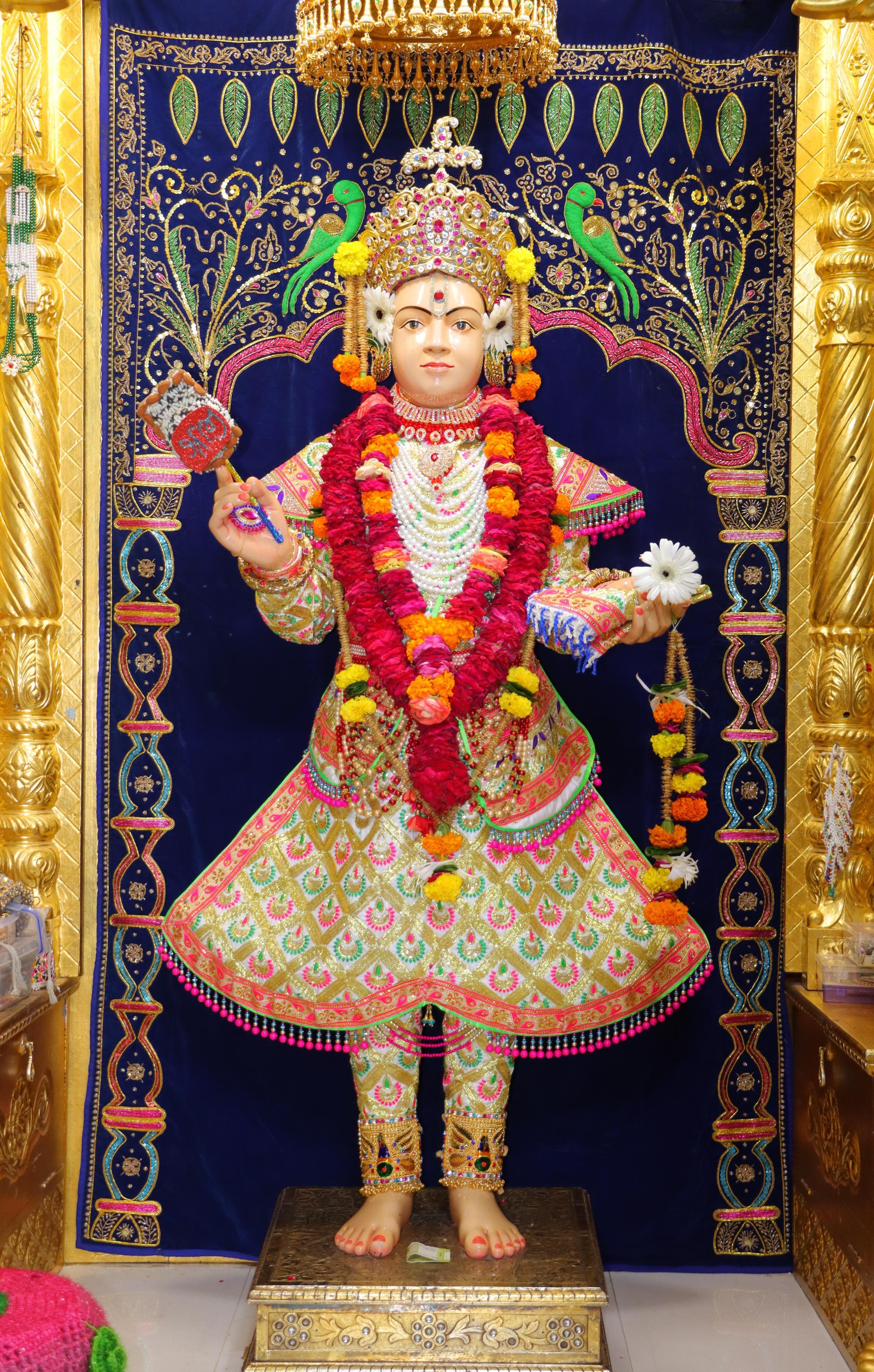 Swaminarayan idol adorned with floral garlands