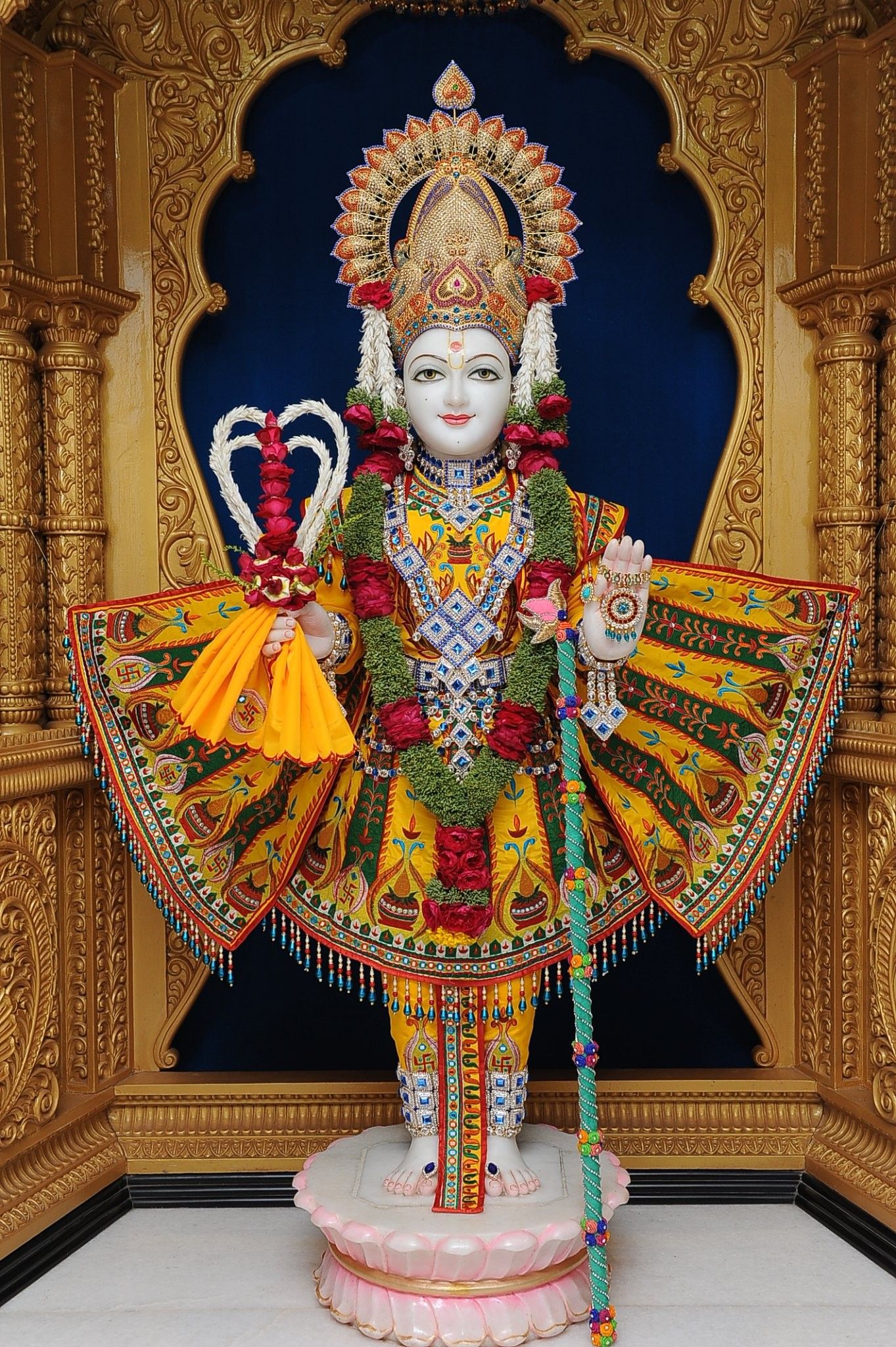 Swaminarayan deity in ornate temple setting