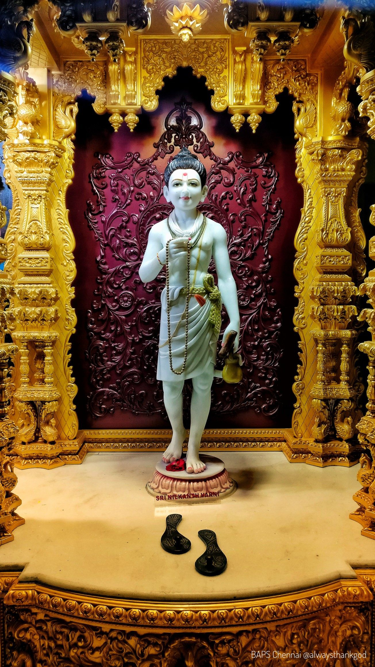 Swaminarayan statue in ornate temple setting