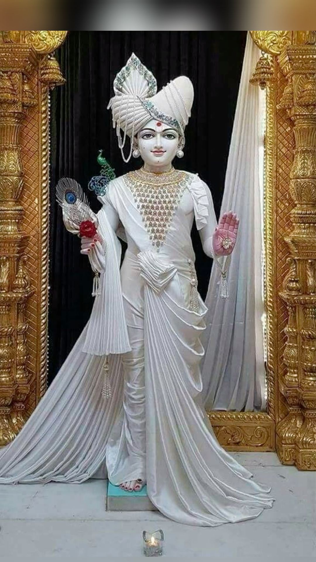 Shri Swaminarayan in ornate white attire