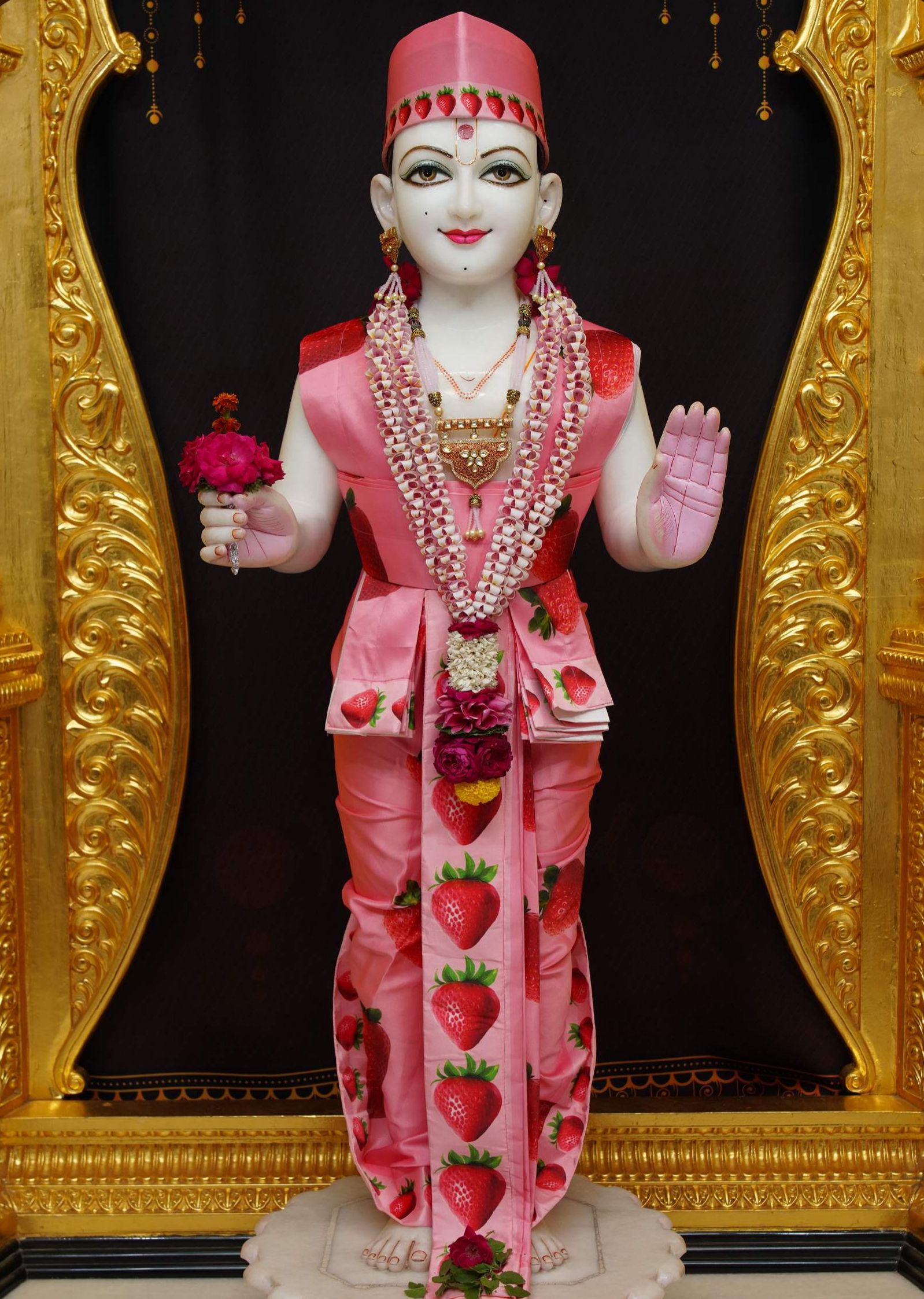 Swaminarayan adorned in strawberry attire