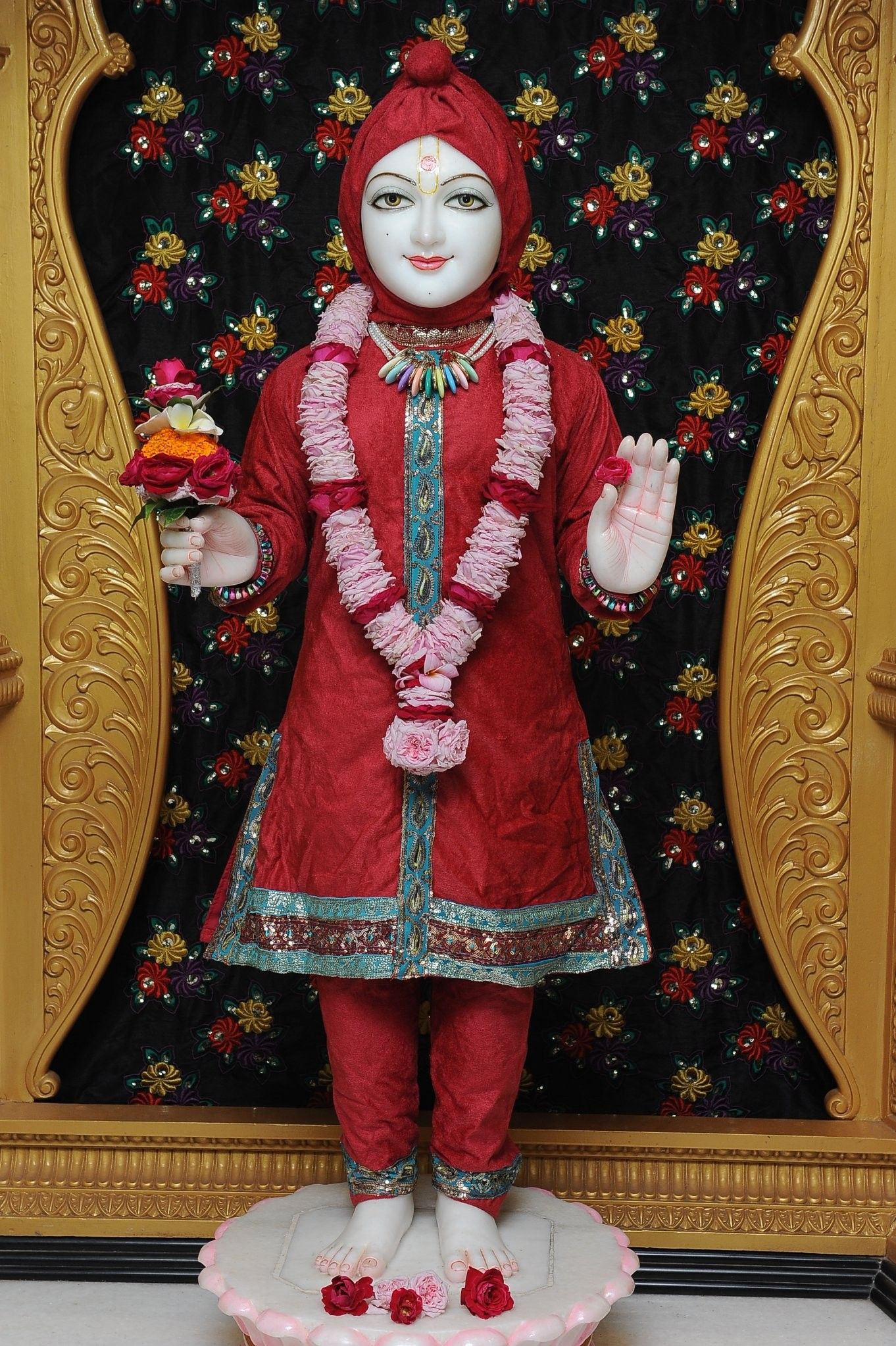 Swaminarayan statue adorned with flowers