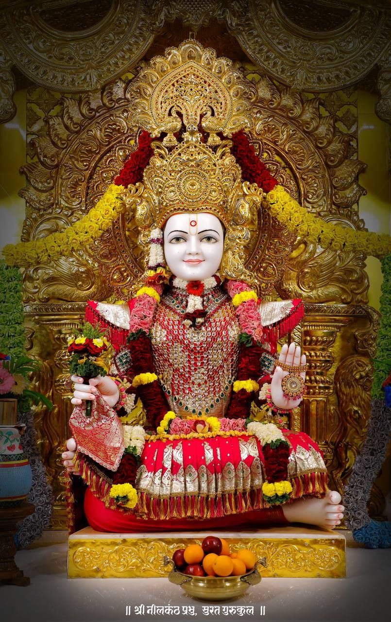 Swaminarayan idol adorned with flowers.