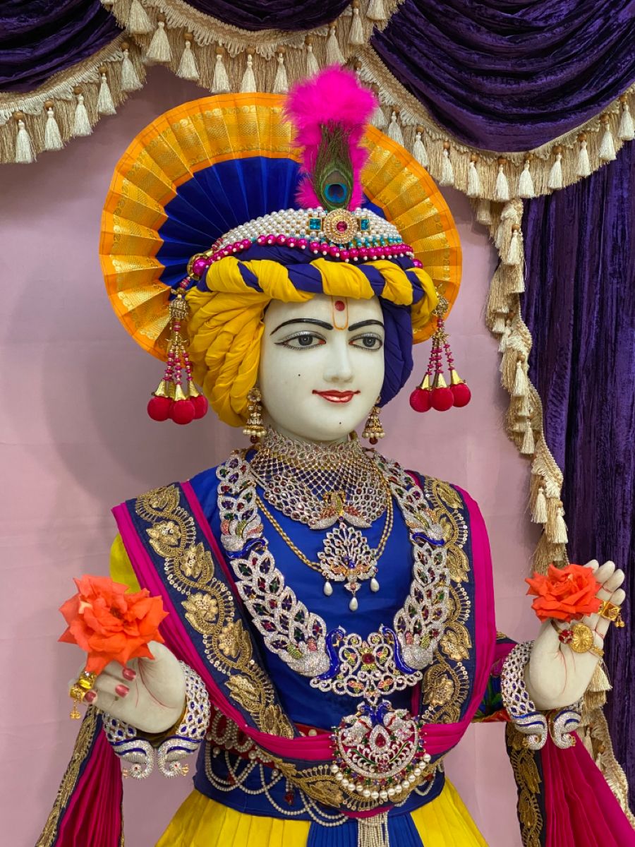 Swaminarayan with peacock feather, divine murti.