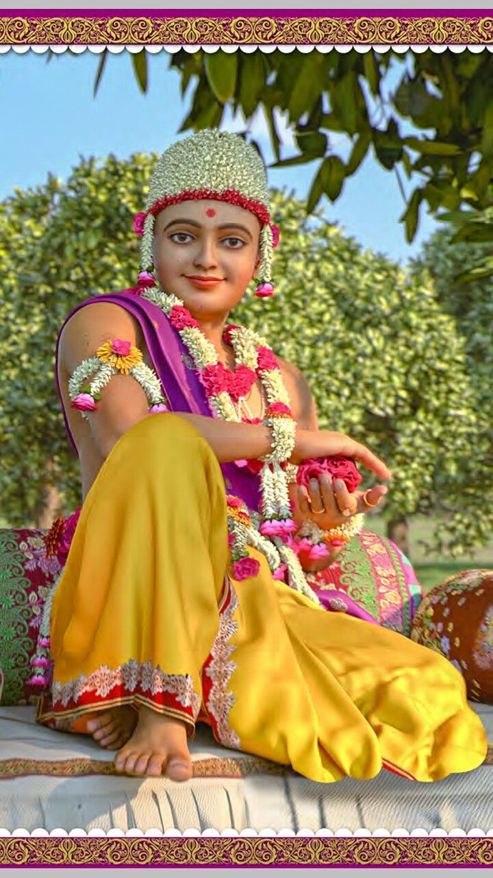 Swaminarayanji sitting amidst lush greenery