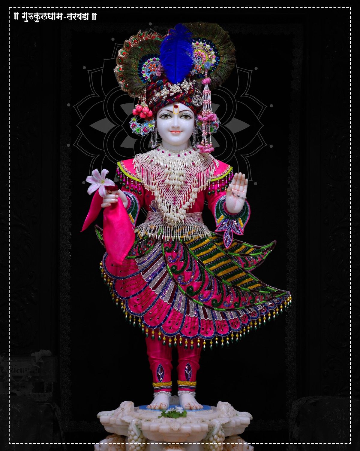 Swaminarayan statue with floral crown