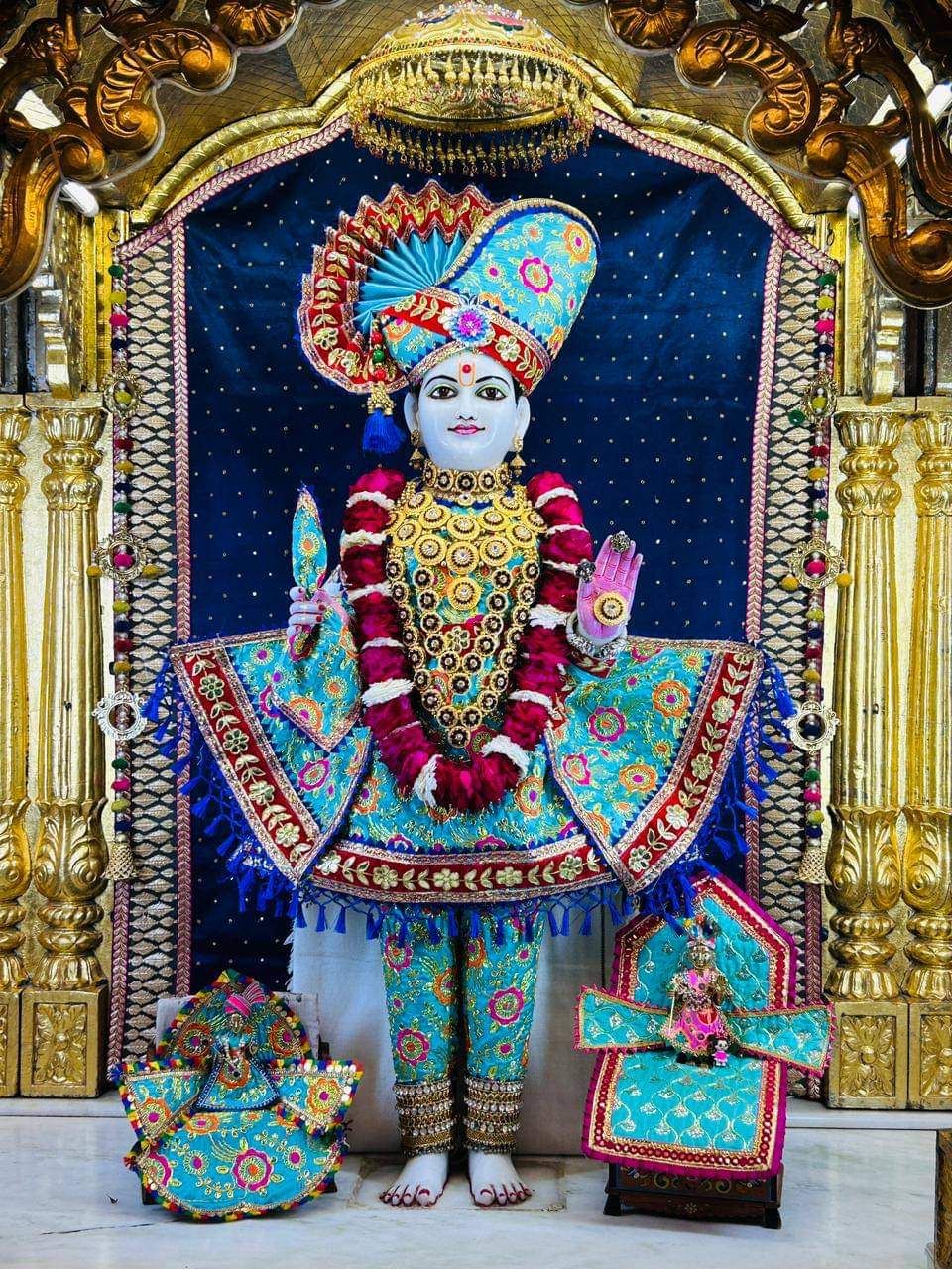 Swaminarayan Bhagwan in ornate temple setting.