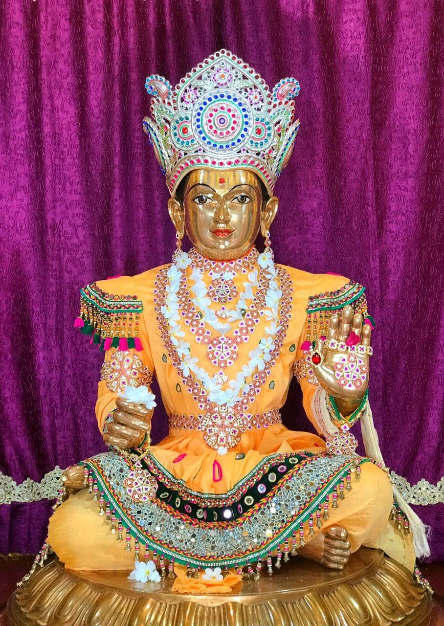Swaminarayan seated in golden attire