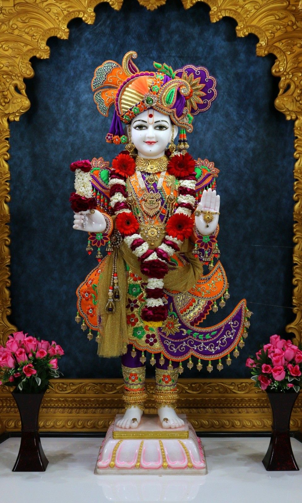 Swaminarayan statue adorned with flowers