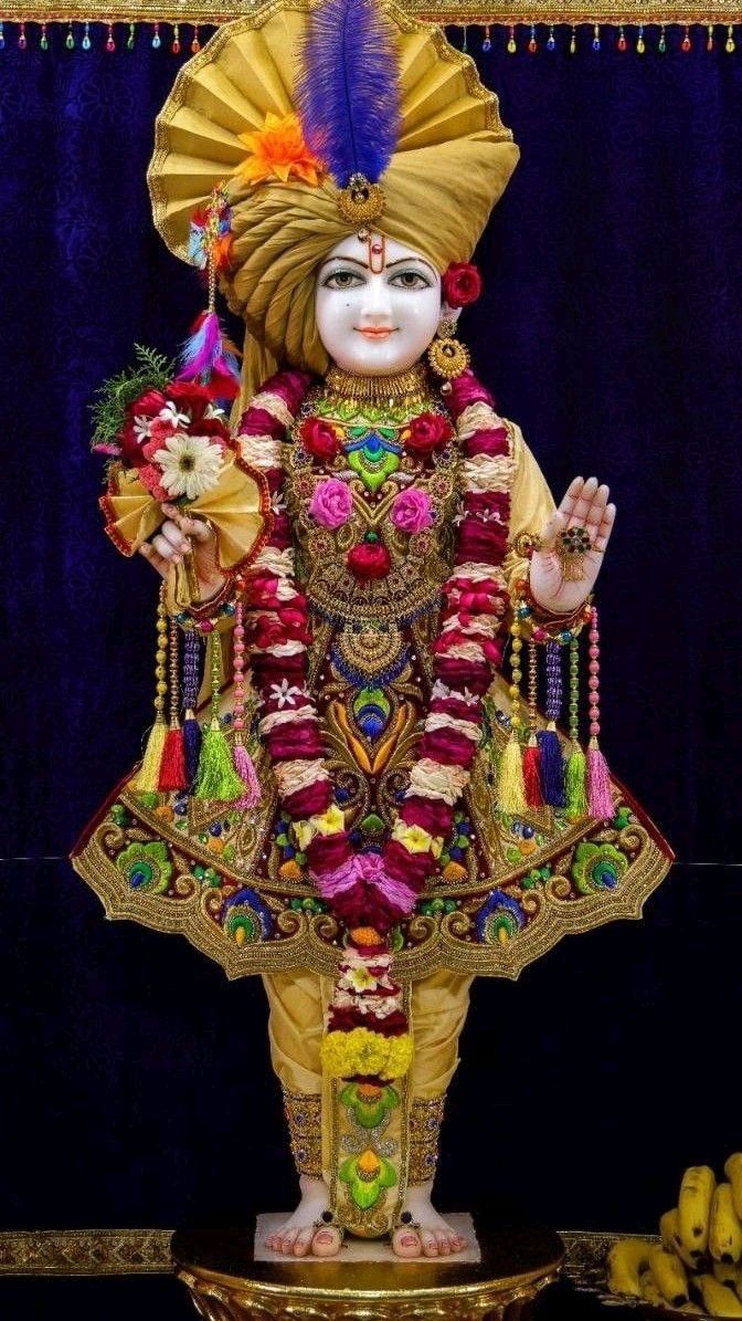 Swaminarayan statue with floral adornments