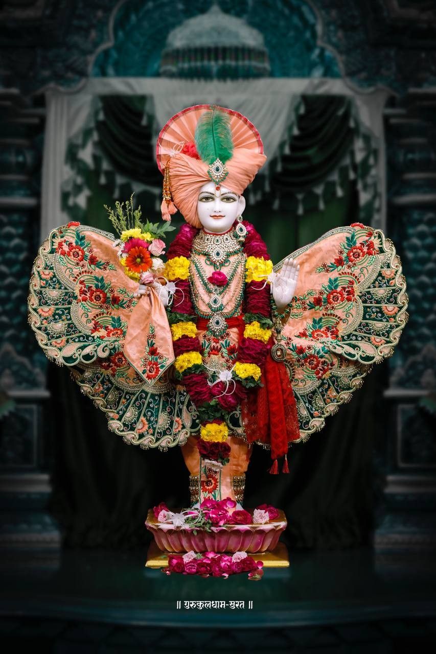 Swaminarayan adorned with flowers and crown