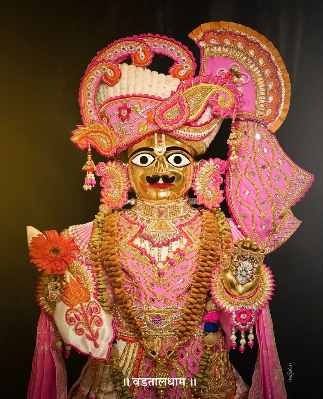 Radiant Swaminarayan deity with floral adornments