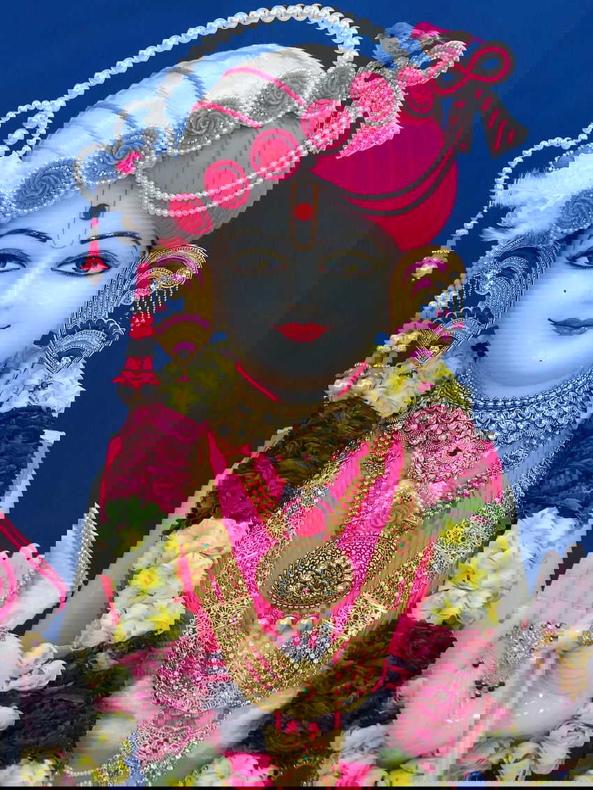 Swaminarayan murti with floral adornments