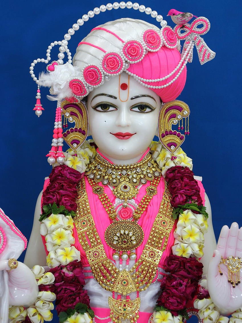 Swaminarayan murti with floral adornments
