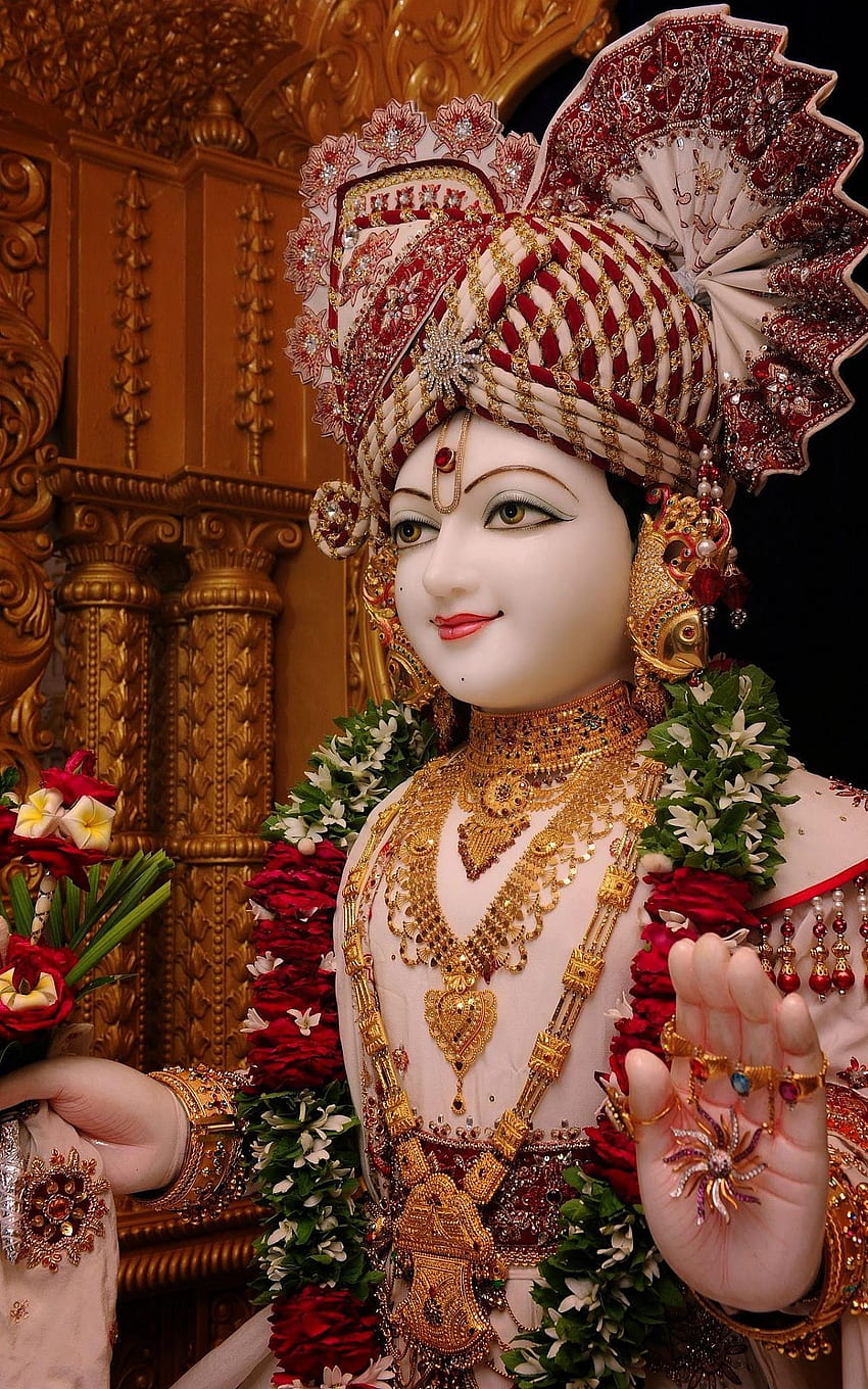 Swaminarayan with gold jewelry and garland
