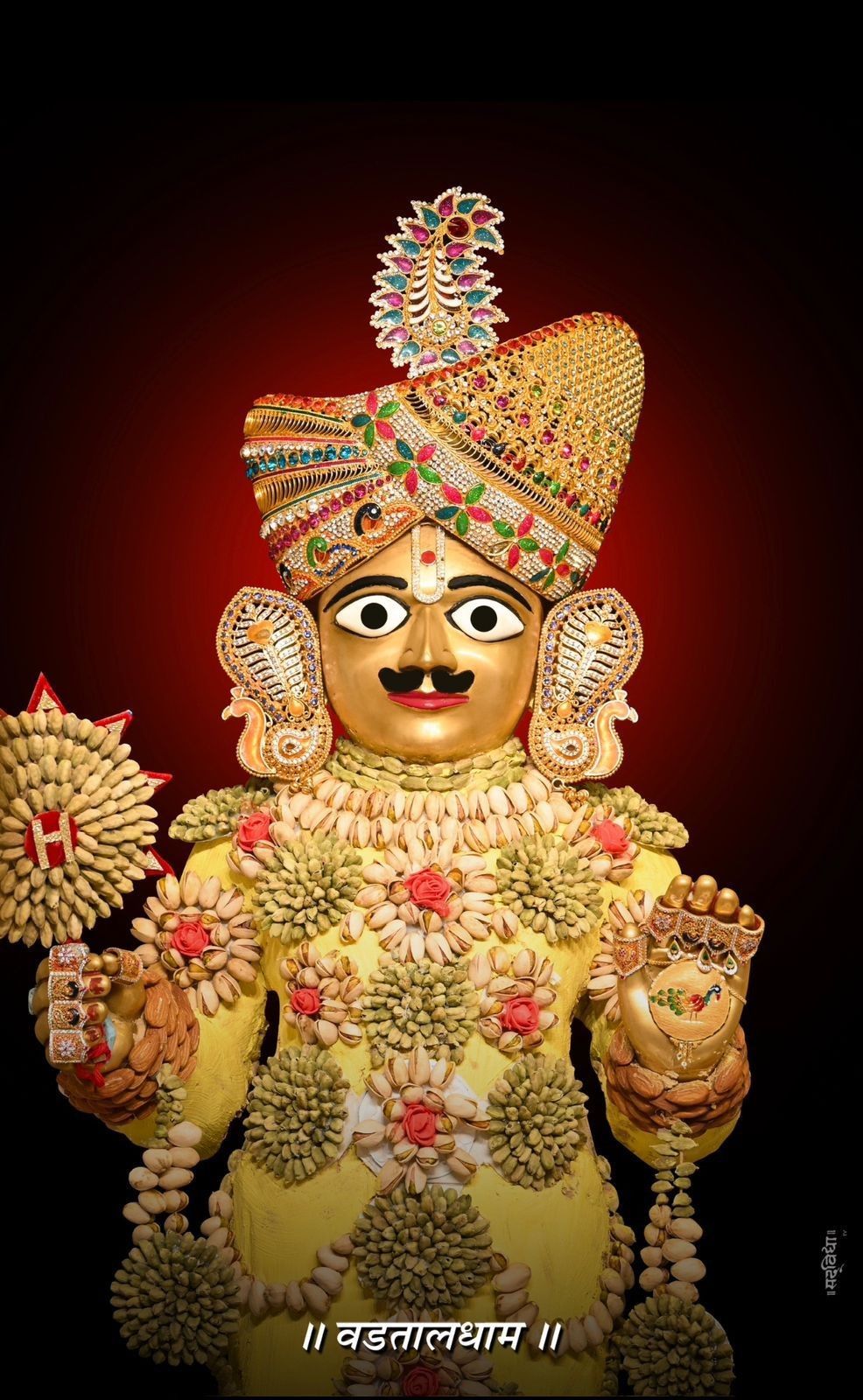 Swaminarayan deity with floral jewelry