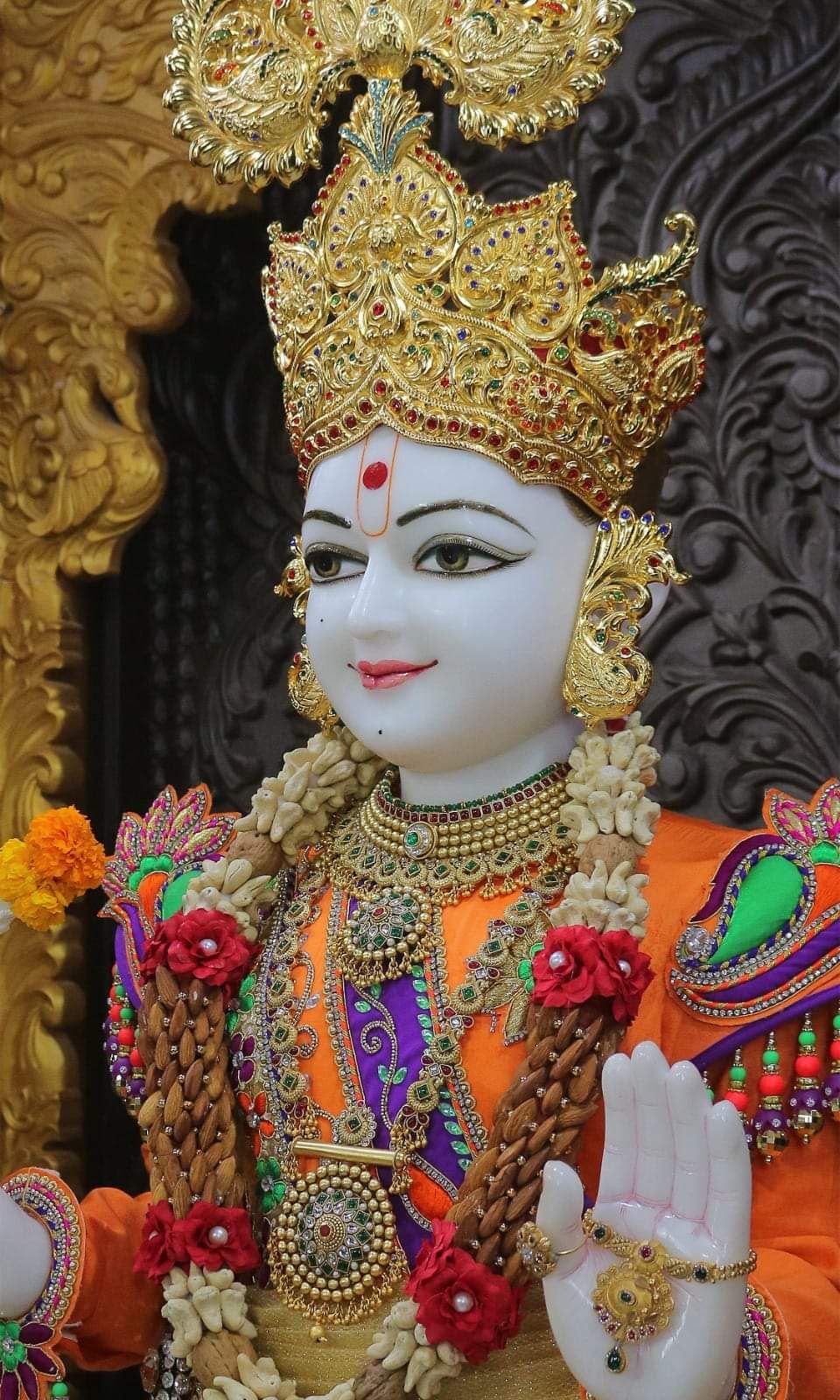 Swaminarayan with golden crown and jewels