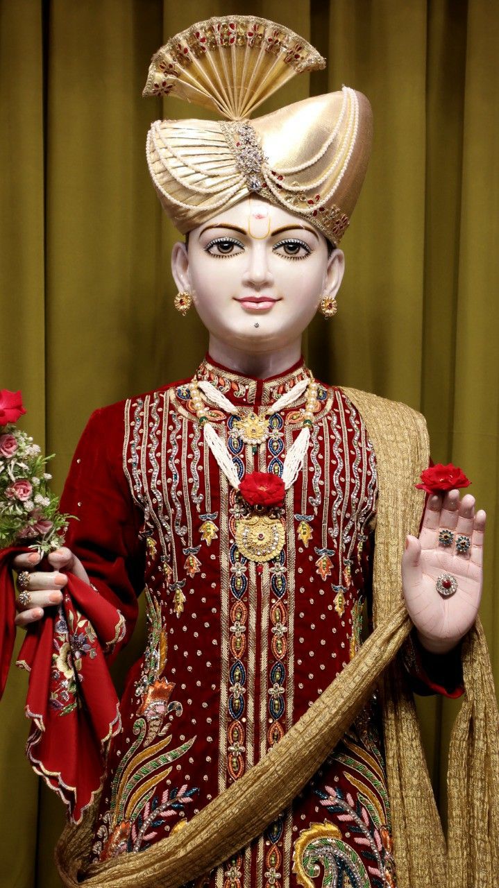Swaminarayan in ornate red attire.