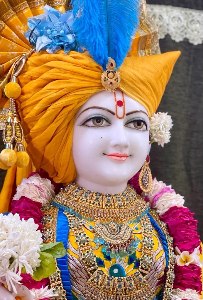 Beautiful Swaminarayan portrait with flowers.