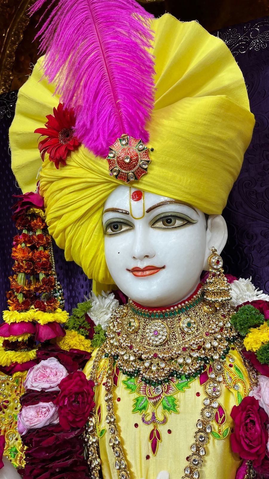 Swaminarayan with yellow turban and flowers