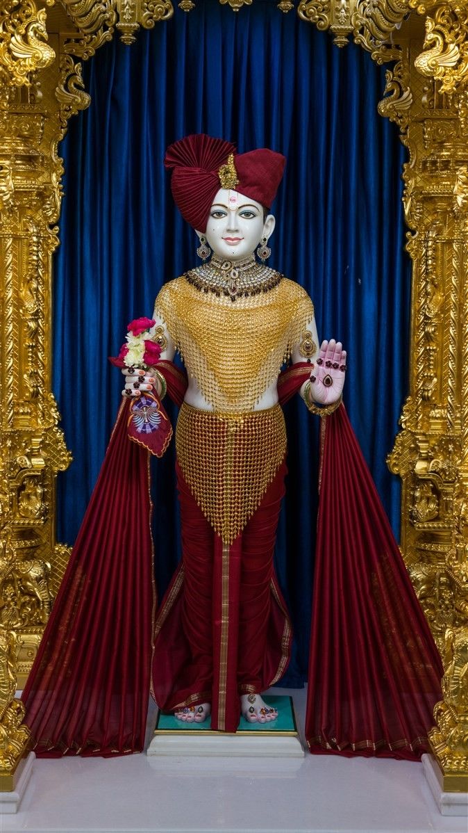 Swaminarayan statue in ornate temple setting