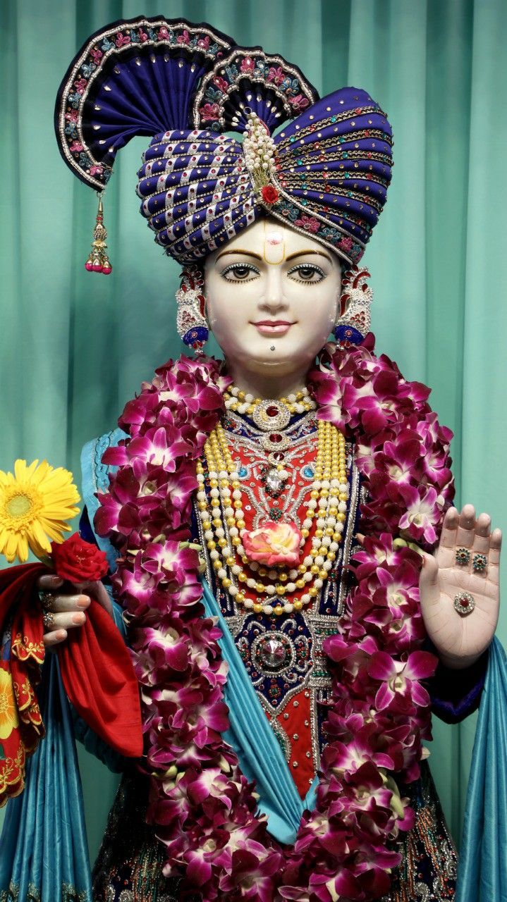 Swaminarayan with floral garland and turban