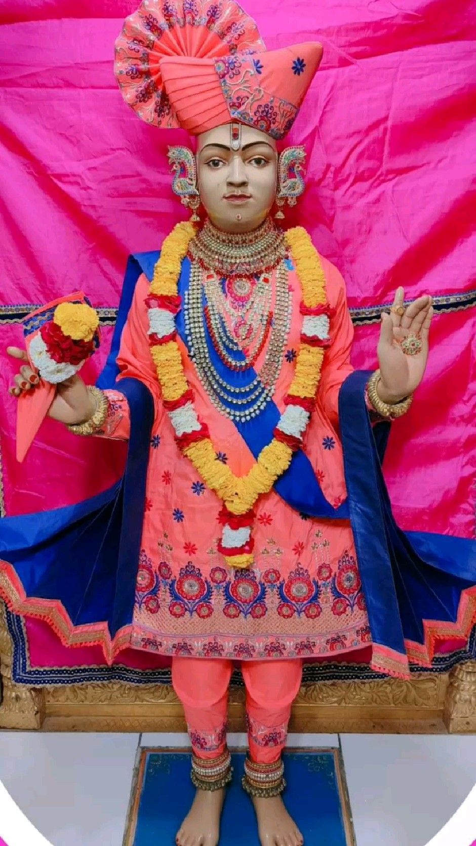 Swaminarayan idol adorned with floral garlands