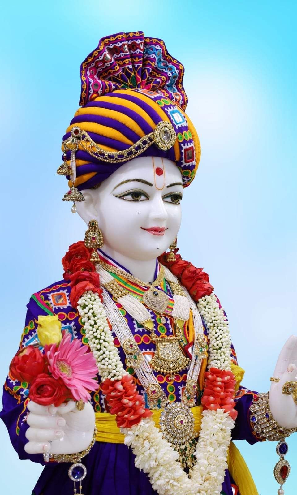 Swaminarayan with ornate headdress and garland