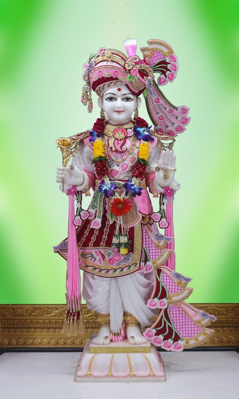 Swaminarayan statue adorned with flowers