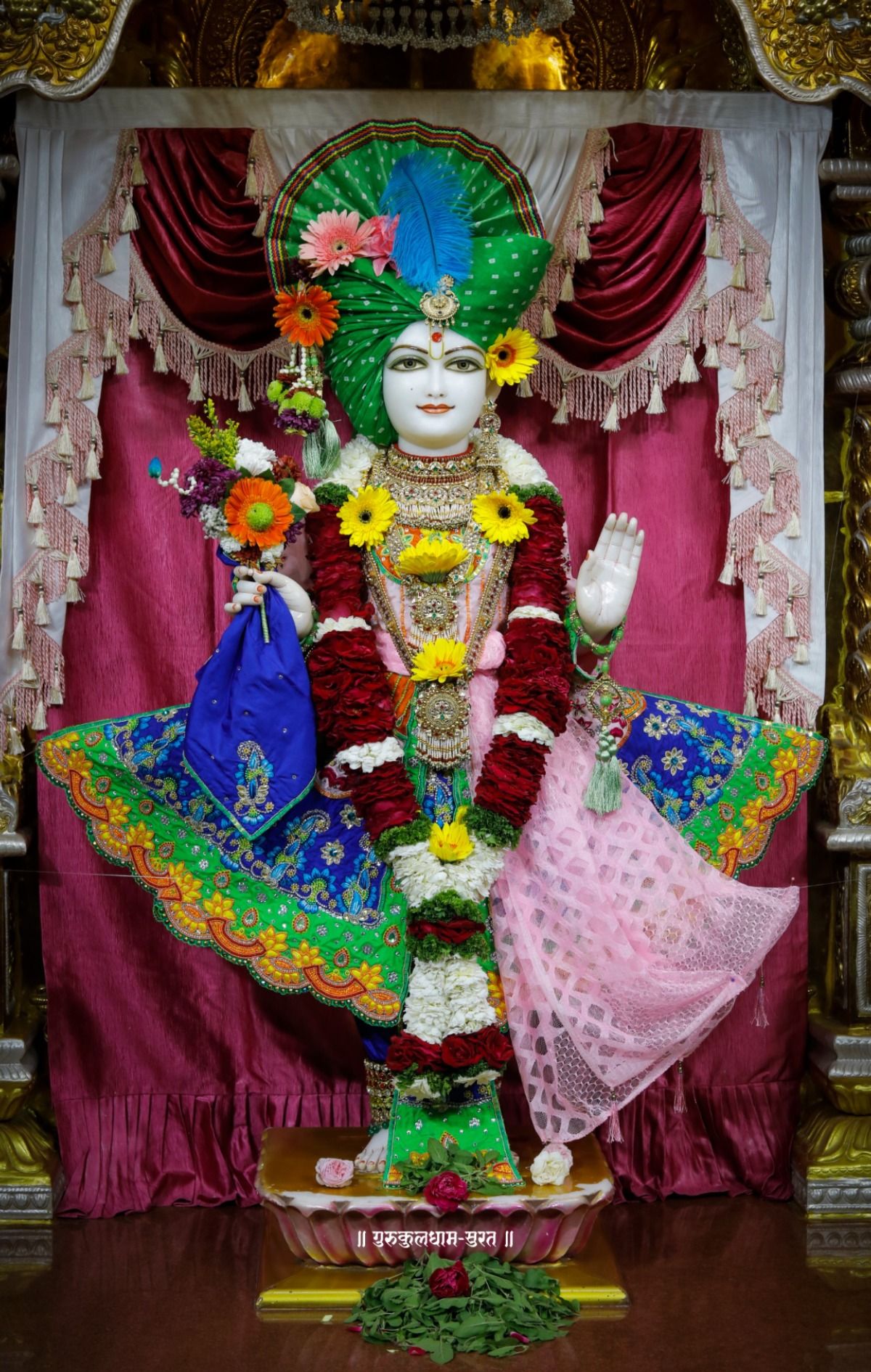 Swaminarayan murti with floral offerings