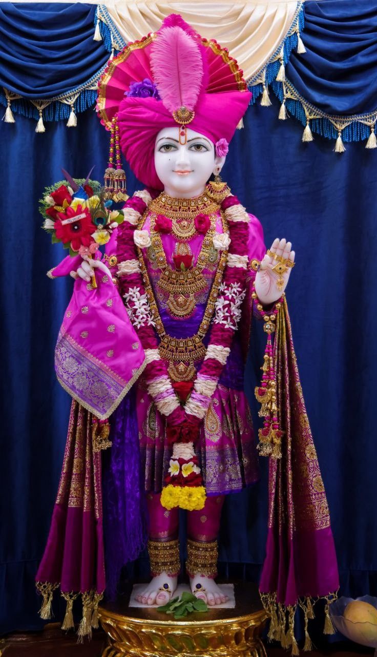 Swaminarayan statue adorned with flowers