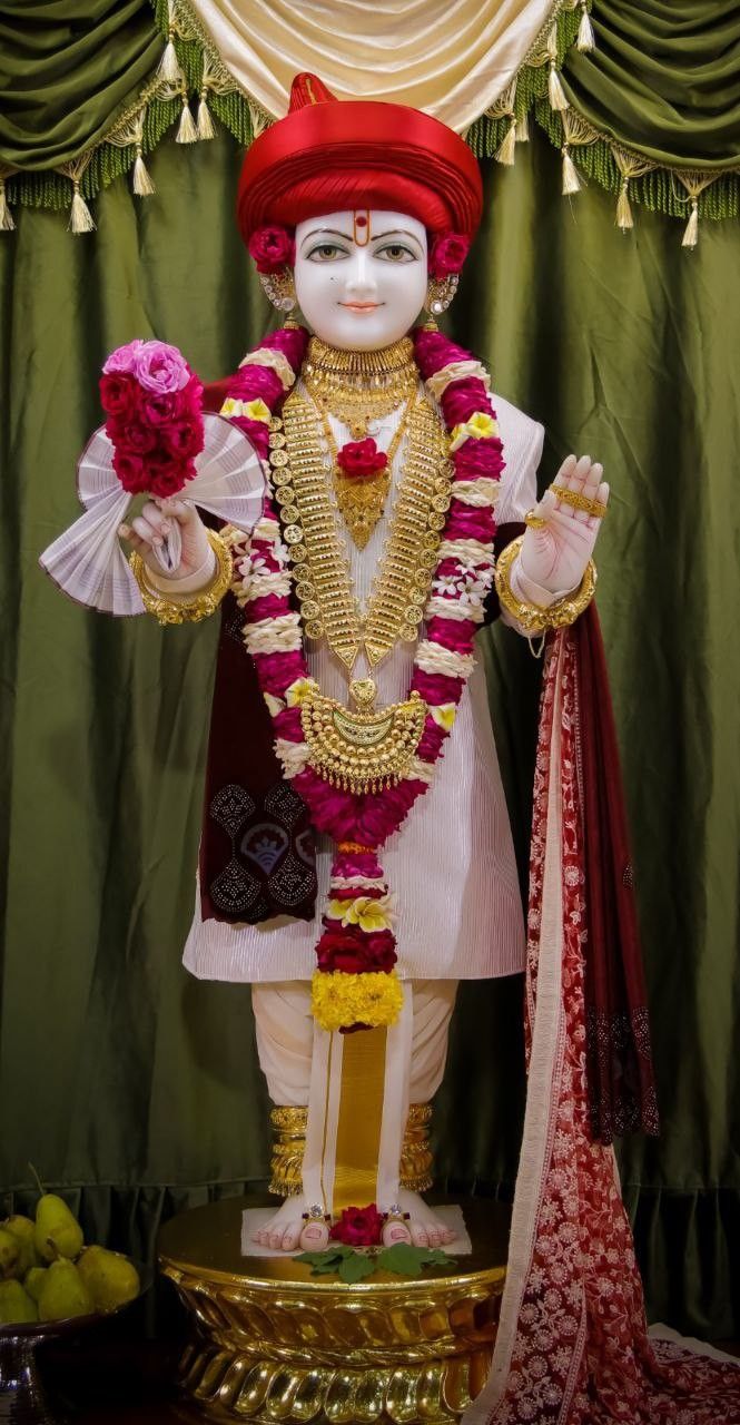 Swaminarayan statue adorned with flowers