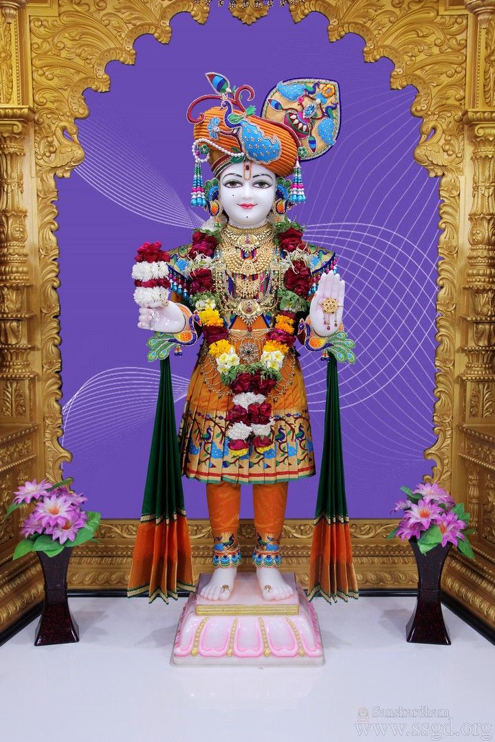 Swaminarayan statue adorned with flowers