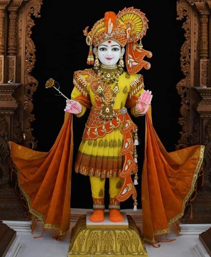 Swaminarayan murti in ornate clothing.