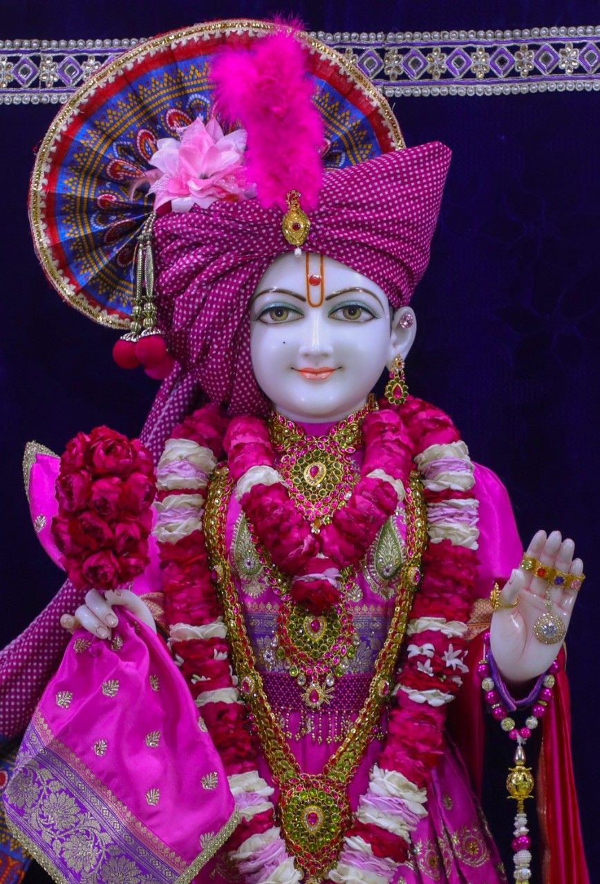 Swaminarayan adorned in pink and gold.