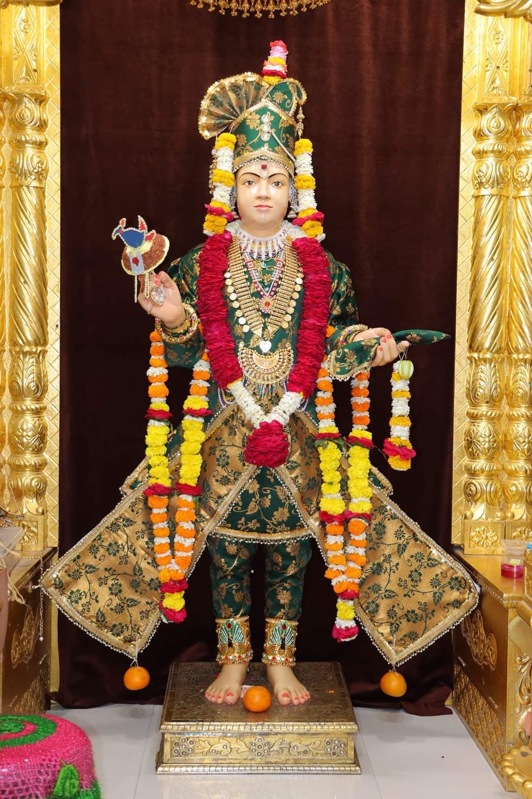 Swaminarayan murti with golden ornaments
