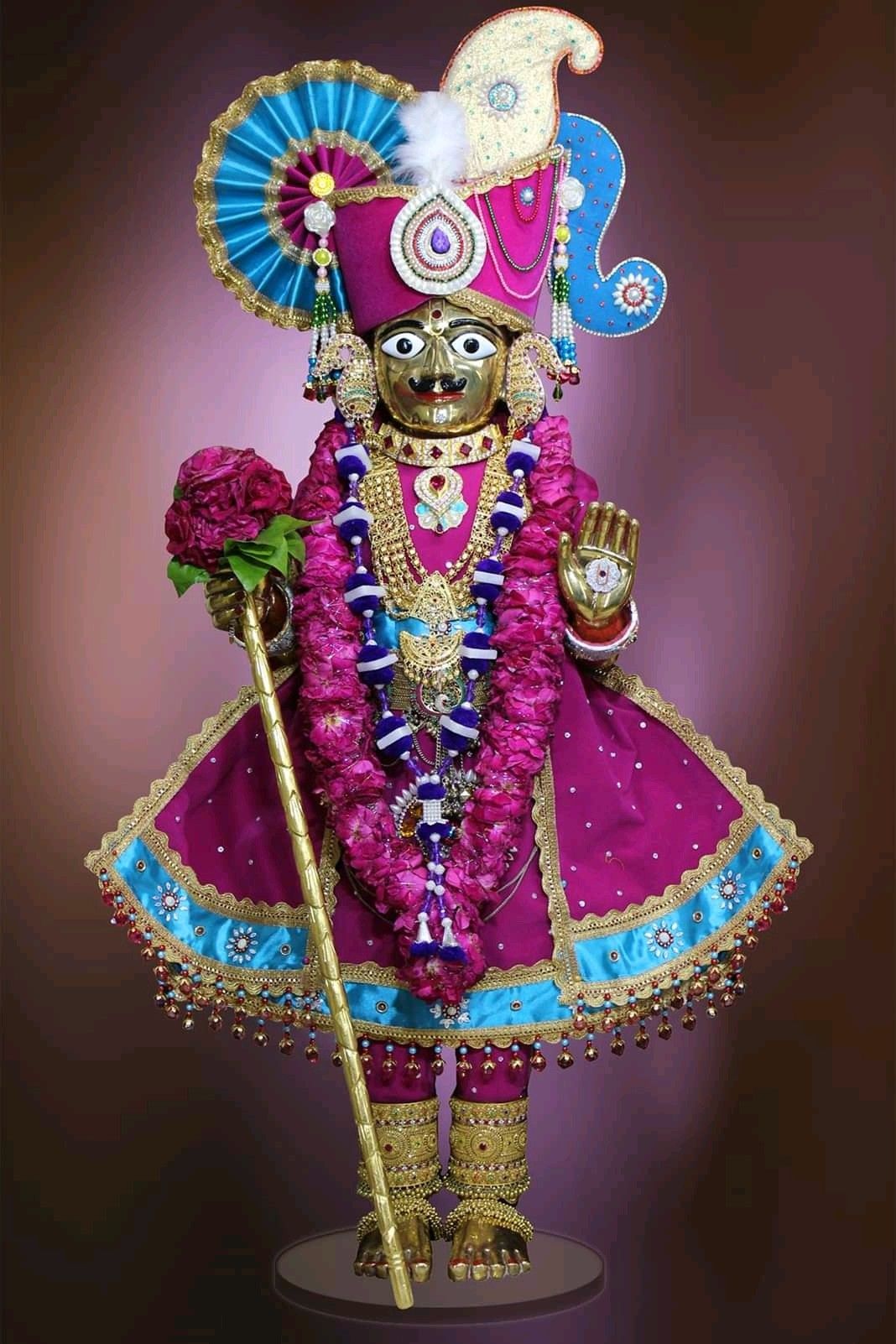 Ornate Swaminarayan idol with floral garland
