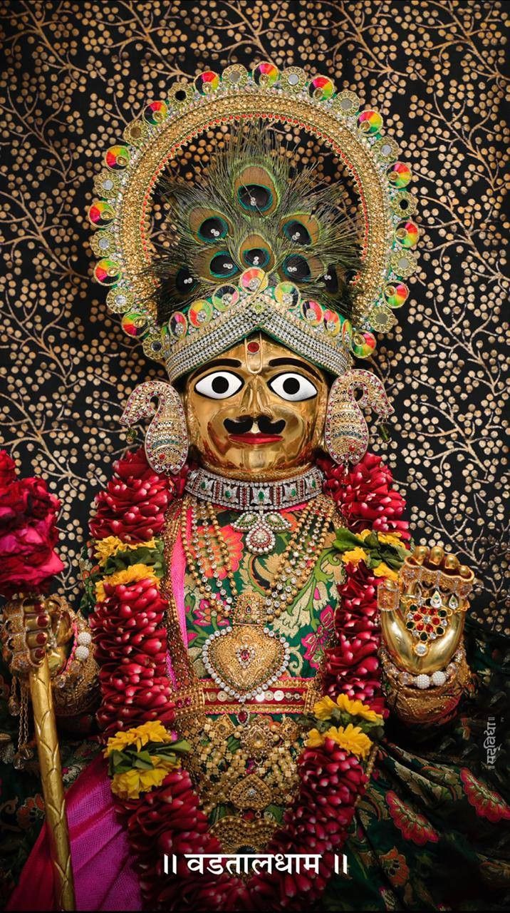 Swaminarayan deity adorned with flowers.