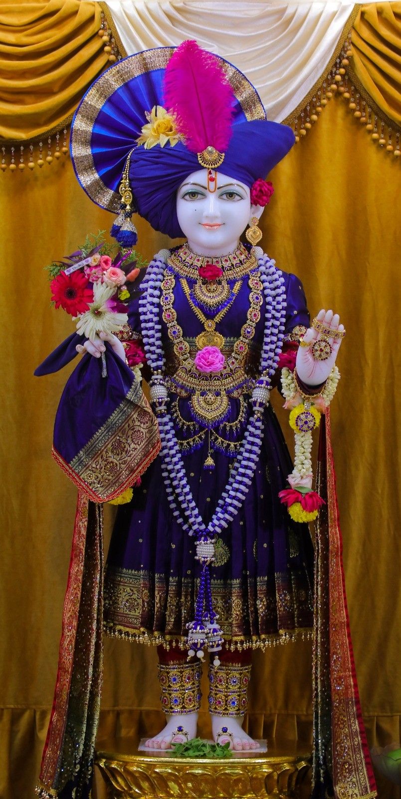 Swaminarayan murti adorned with jewelry