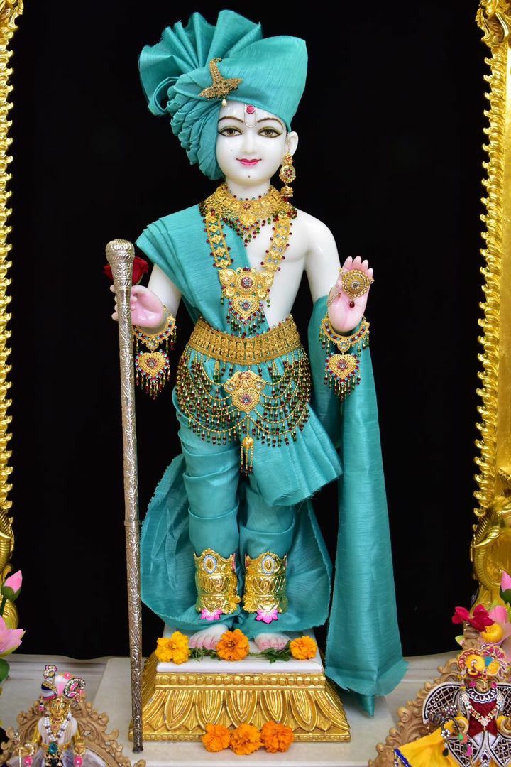Swaminarayan deity adorned in golden jewelry